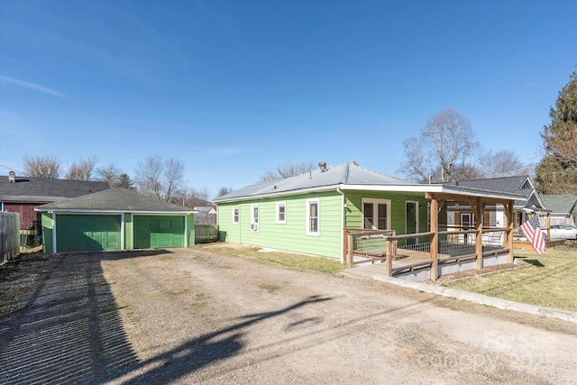 view of front of home with a garage and an outdoor structure