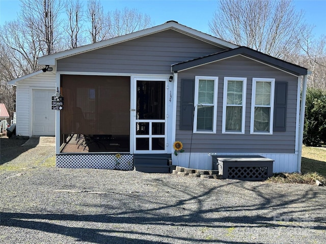 manufactured / mobile home featuring entry steps, a sunroom, and a garage