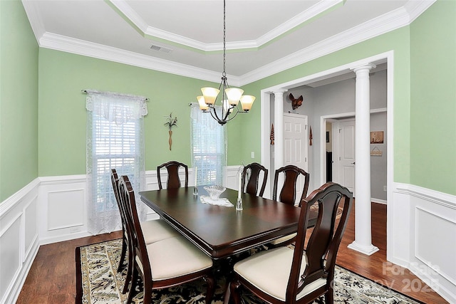 dining area featuring dark wood-style floors, wainscoting, visible vents, and ornate columns