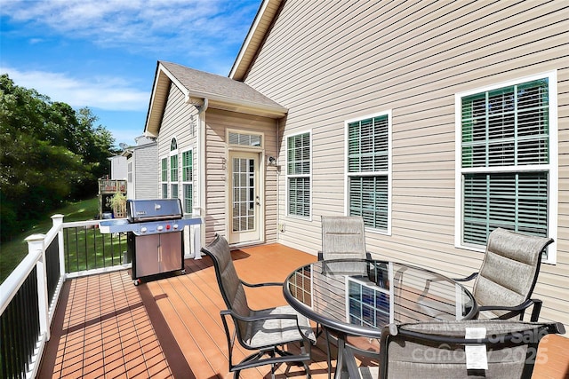 wooden deck featuring outdoor dining area