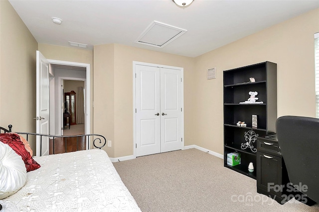 carpeted bedroom with attic access, a closet, and baseboards