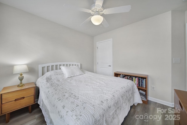 bedroom featuring wood finished floors, a ceiling fan, and baseboards