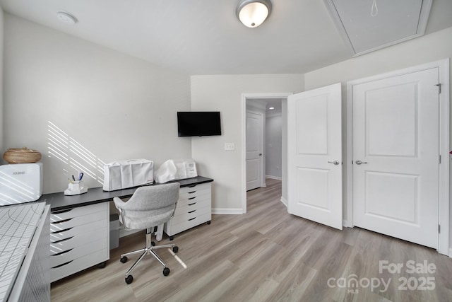 office space with light wood-style flooring and baseboards