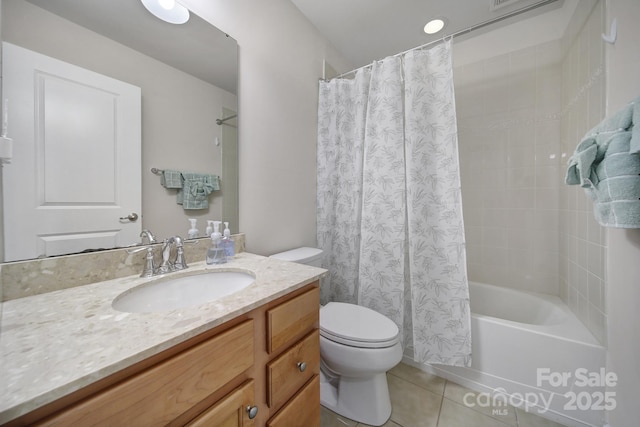 bathroom featuring tile patterned flooring, vanity, toilet, and shower / bath combo with shower curtain