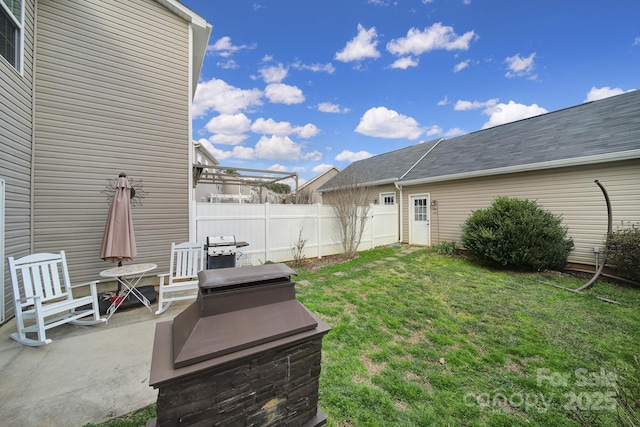 view of yard with fence and a patio