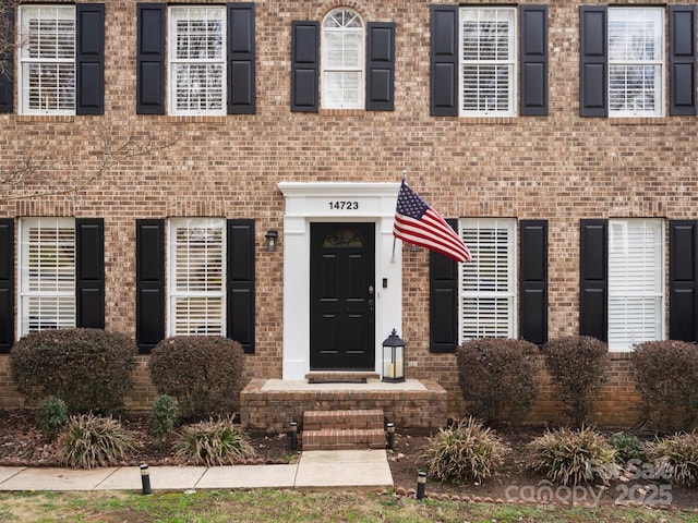 entrance to property with brick siding