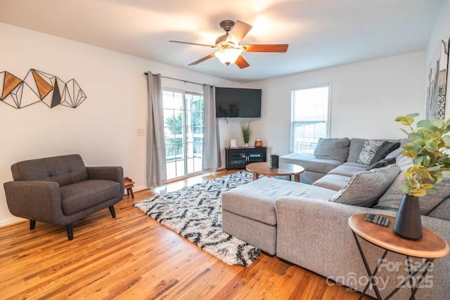 living area with plenty of natural light, ceiling fan, and light wood-type flooring