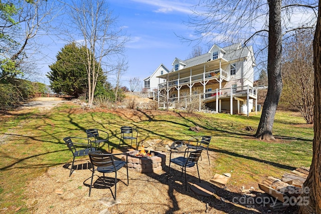 view of yard with a fire pit and a wooden deck