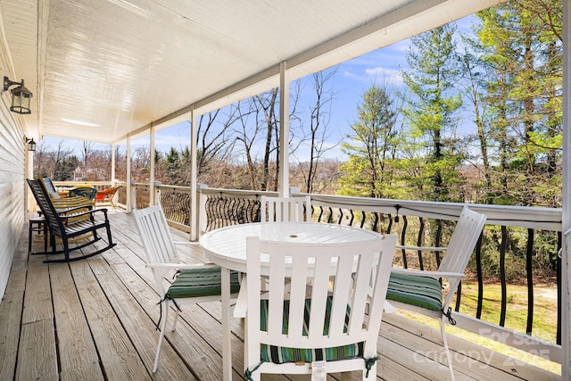 wooden terrace featuring outdoor dining area