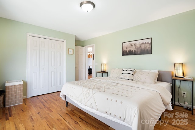 bedroom featuring light wood-type flooring and a closet