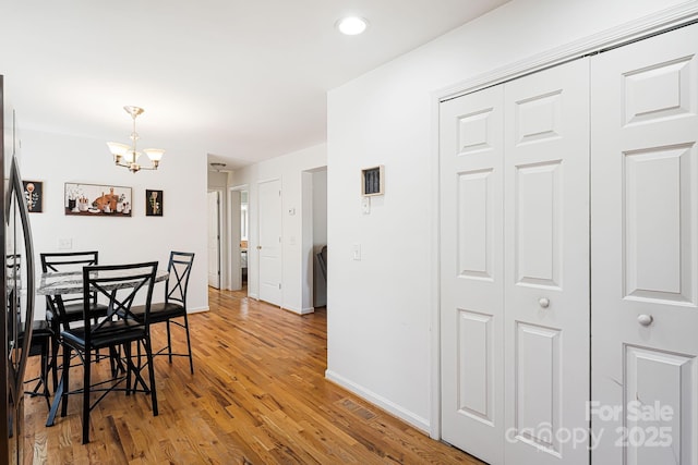 dining space featuring recessed lighting, wood finished floors, visible vents, baseboards, and a chandelier
