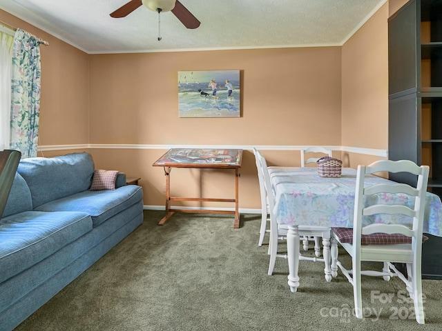 dining room featuring carpet floors, ceiling fan, baseboards, and crown molding