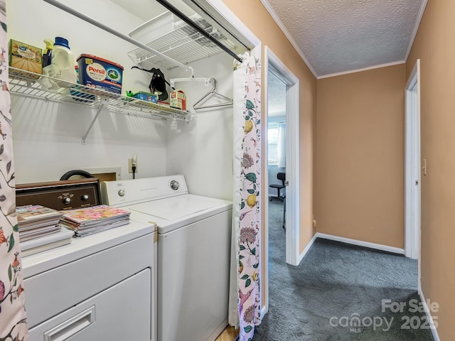 clothes washing area with laundry area, baseboards, washing machine and clothes dryer, carpet, and a textured ceiling