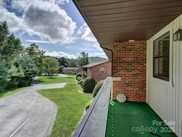 view of yard with a balcony