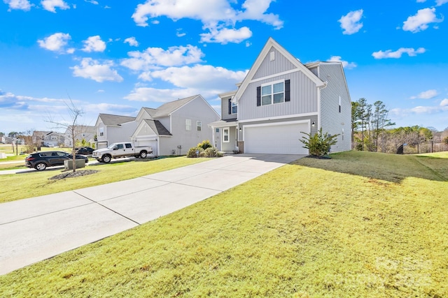 view of front of home with a garage, concrete driveway, a residential view, board and batten siding, and a front yard