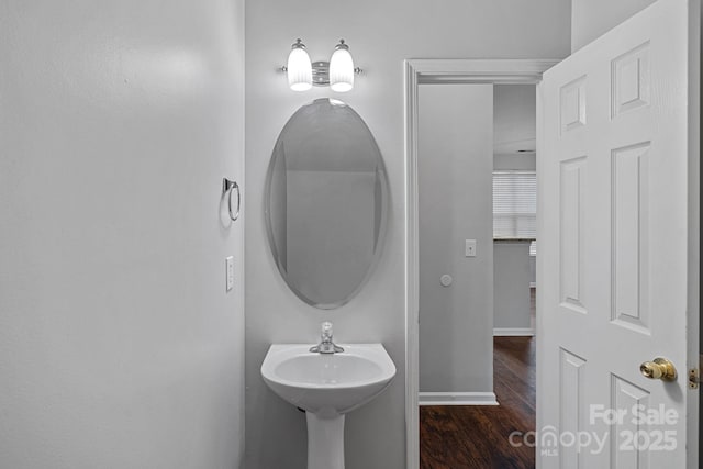 bathroom featuring baseboards and wood finished floors