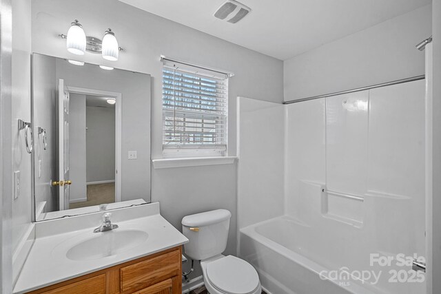 full bathroom with visible vents, toilet, vanity, and shower / washtub combination