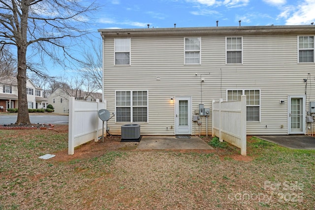 back of property featuring a patio area, a lawn, central AC, and fence