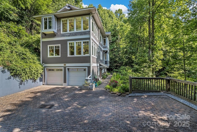 view of front of house with a garage and decorative driveway