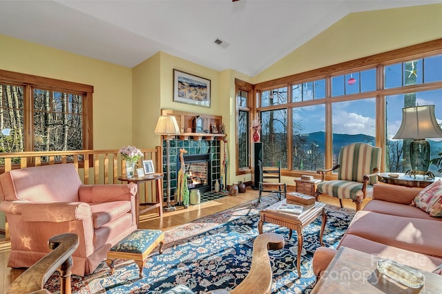 322 Crestview Dr, Black Mountain, NC 28711 - living area with a tiled fireplace, lofted ceiling, a mountain view, and visible vents