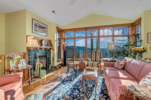 322 Crestview Dr, Black Mountain, NC 28711 - living area featuring visible vents, a tile fireplace, lofted ceiling, and wood finished floors