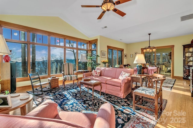 322 Crestview Dr, Black Mountain, NC 28711 - living room with visible vents, lofted ceiling, wood finished floors, and ceiling fan with notable chandelier