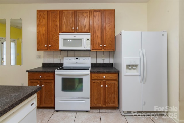 kitchen featuring white appliances, tasteful backsplash, and brown cabinetry