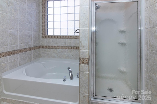 full bath with a garden tub and a shower stall