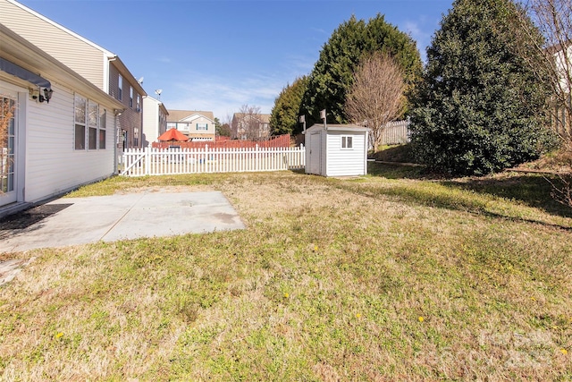 view of yard with a patio area, a shed, fence, and an outdoor structure