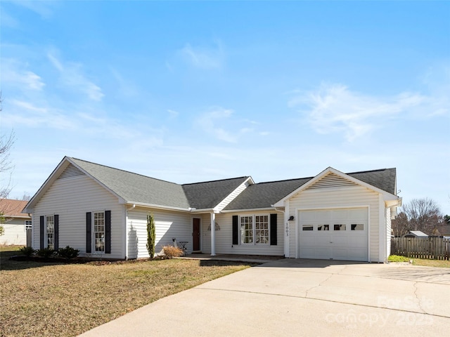 ranch-style house featuring a garage, a front lawn, and concrete driveway