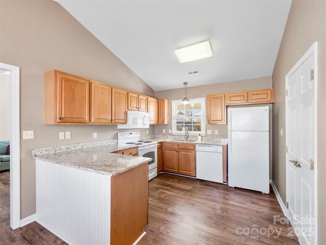 kitchen featuring white appliances, visible vents, light stone countertops, vaulted ceiling, and a sink