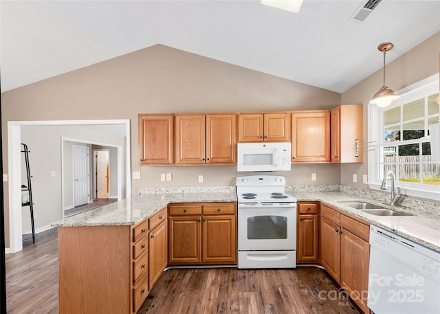 kitchen featuring light stone counters, a peninsula, white appliances, a sink, and dark wood finished floors