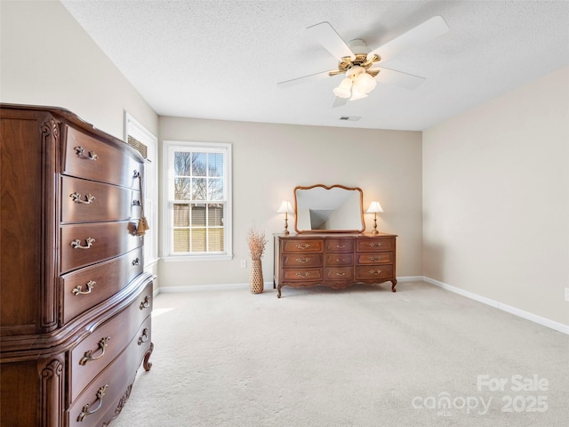 bedroom with a textured ceiling, ceiling fan, light colored carpet, visible vents, and baseboards