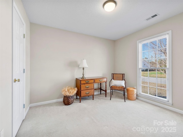 living area with carpet, visible vents, and baseboards