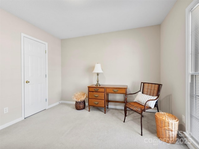 living area featuring carpet flooring and baseboards