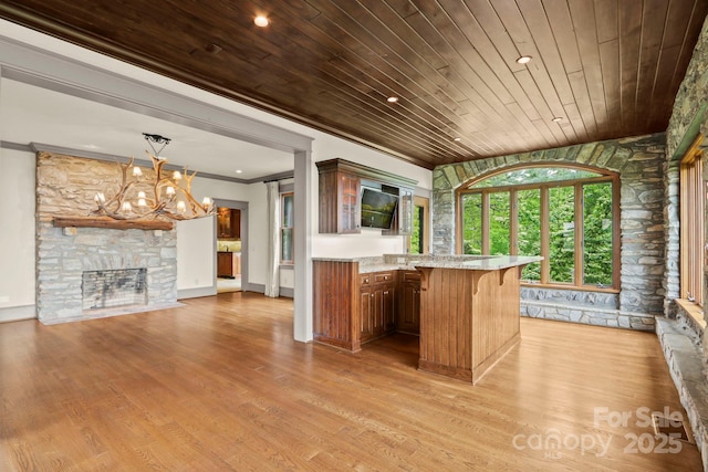 1245 Laurel Ln, Blowing Rock, NC 28605 - kitchen with wooden ceiling, crown molding, a chandelier, a breakfast bar, and light wood-style flooring