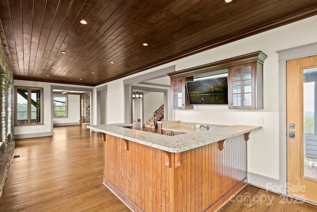 1245 Laurel Ln, Blowing Rock, NC 28605 - kitchen with crown molding, baseboards, wood ceiling, a kitchen breakfast bar, and light stone countertops