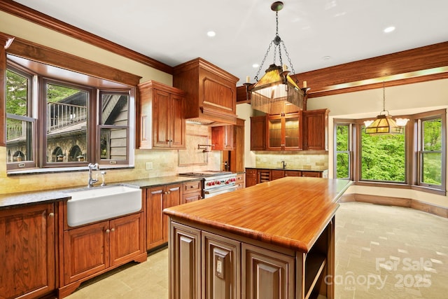 1245 Laurel Ln, Blowing Rock, NC 28605 - kitchen with a sink, stainless steel stove, a chandelier, decorative backsplash, and decorative light fixtures