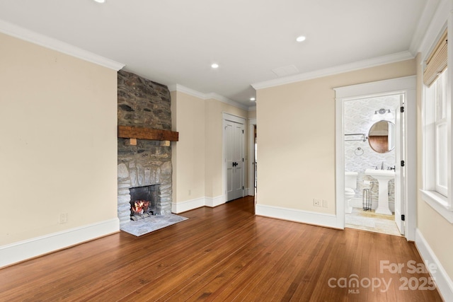 1245 Laurel Ln, Blowing Rock, NC 28605 - unfurnished living room featuring a stone fireplace, hardwood / wood-style floors, recessed lighting, baseboards, and crown molding