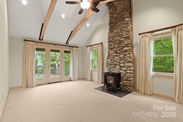 1245 Laurel Ln, Blowing Rock, NC 28605 - unfurnished living room with baseboards, a wood stove, carpet floors, beam ceiling, and ceiling fan