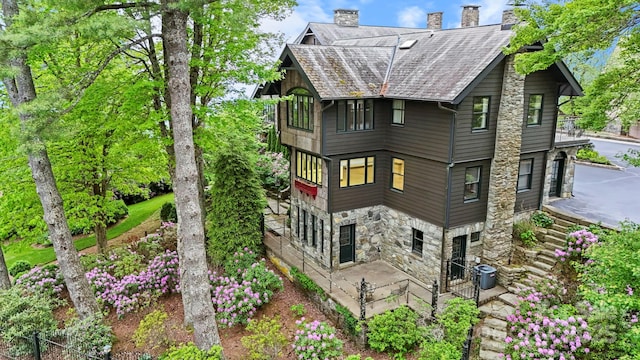 1245 Laurel Ln, Blowing Rock, NC 28605 - back of house with stone siding, a chimney, a patio, central air condition unit, and stairway