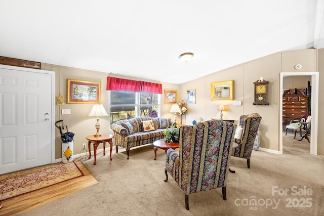 carpeted living room with lofted ceiling and baseboards