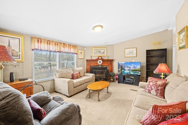 living area featuring carpet floors, a premium fireplace, and vaulted ceiling