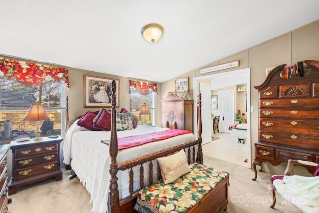 bedroom featuring vaulted ceiling and light carpet