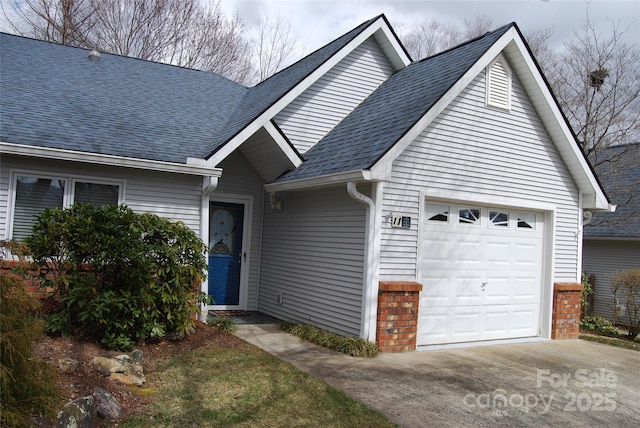 ranch-style home featuring a shingled roof, driveway, and an attached garage