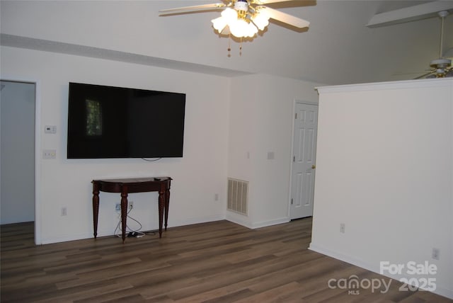 unfurnished living room featuring a ceiling fan, visible vents, baseboards, and wood finished floors