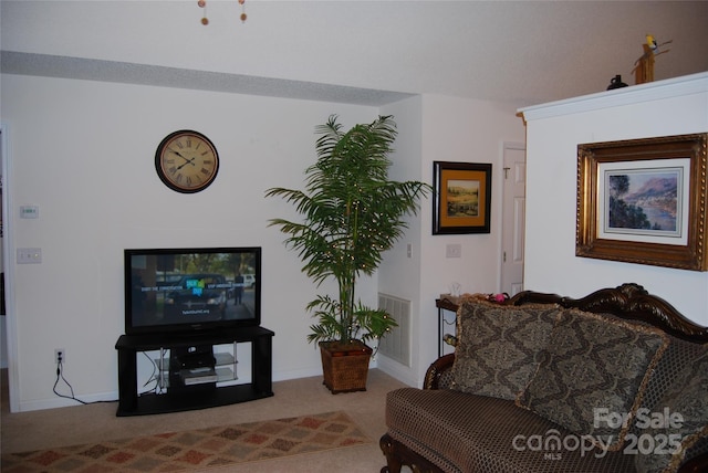 carpeted living area with visible vents and baseboards