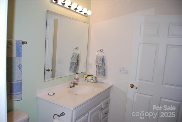 bathroom featuring toilet and vanity