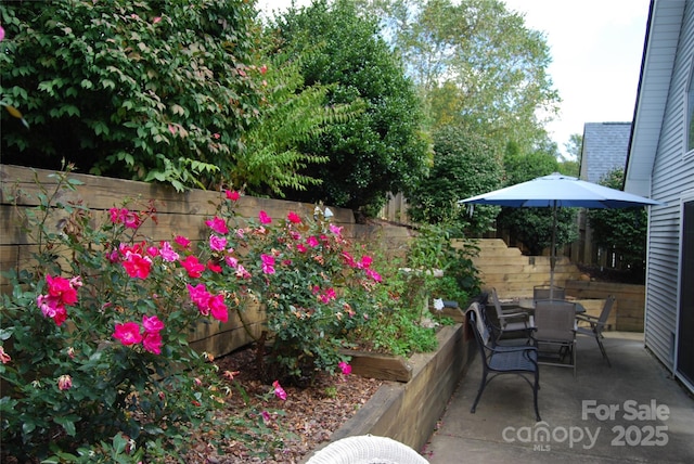 view of patio with outdoor dining space and a fenced backyard