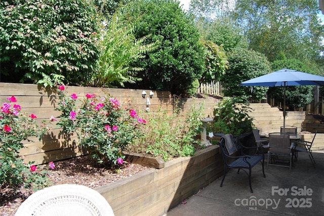 view of patio with fence and outdoor dining space